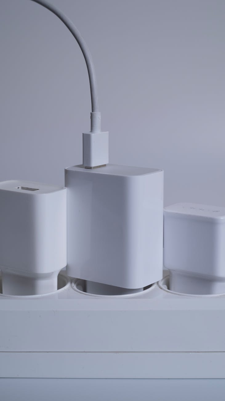 many chargers are connected to an electrical outlet on a white background